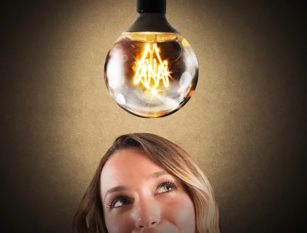 Businesswoman with shiny lightbulb — Stock Photo, Image