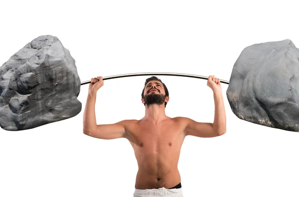 Goofy guy lifting a barbell with boulders — Stock Photo, Image