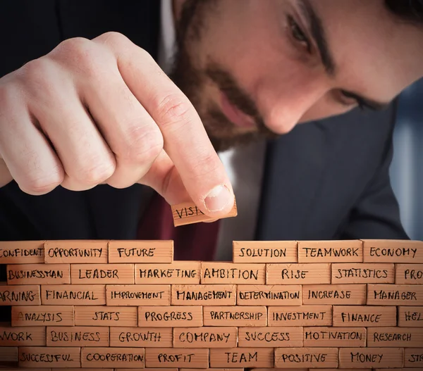 Businessman builds a staircase — Stock Photo, Image