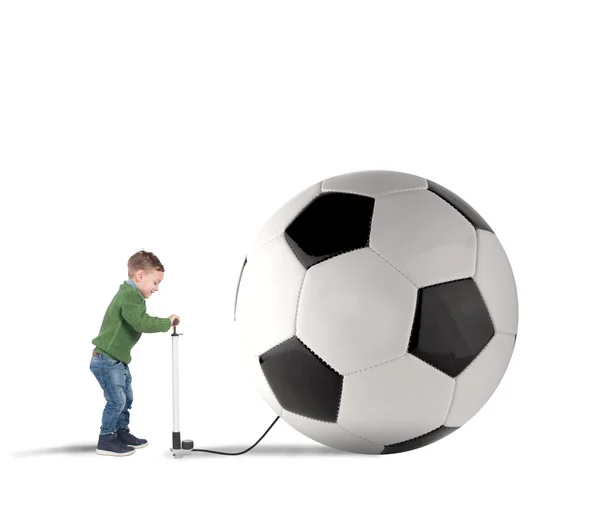 Boy pumping up big ball — Stock Photo, Image