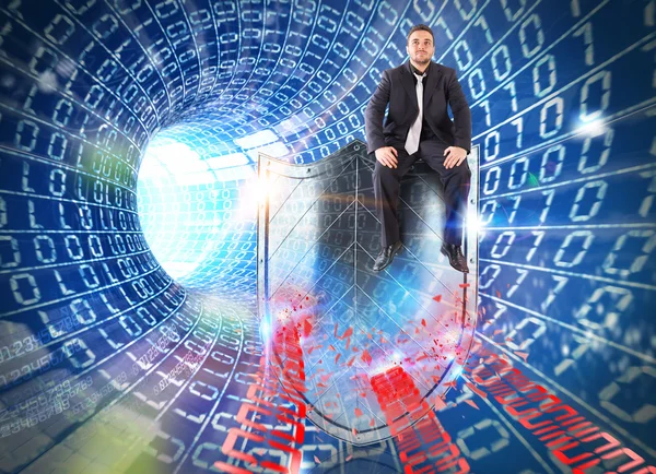 Businessman sitting on a shield — Stock Photo, Image