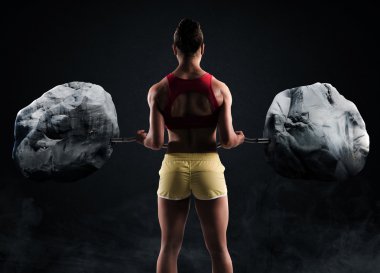 Muscular woman raising boulders with a barbell clipart