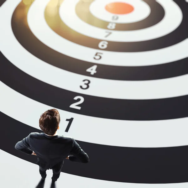 Man on a big target with numbers — Stock Photo, Image