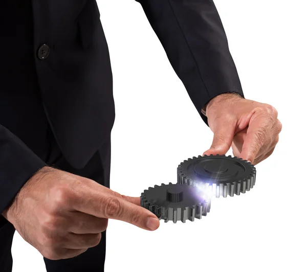 Businessman holding gears — Stock Photo, Image