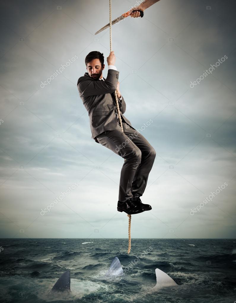 Man hanging from a rope cut by a saw — Stock Photo © alphaspirit #115831086