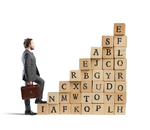 Businessman climbing a staircase cubes — Stock Photo, Image