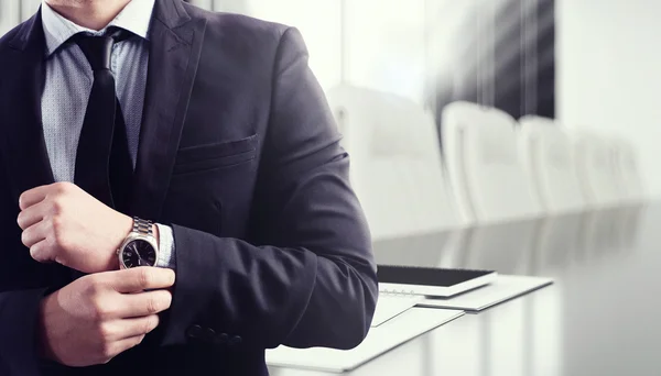 Businessman adjusting his watch — Stock Photo, Image