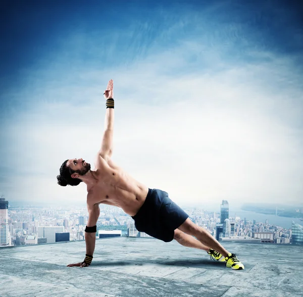 Homem muscular em uma posição pilates — Fotografia de Stock