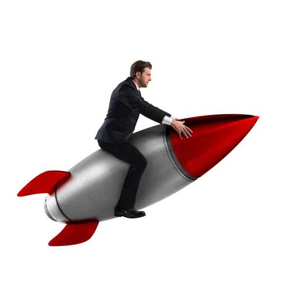 Geschäftsmann sitzt auf einer Rakete — Stockfoto