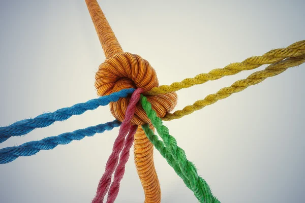 Colored ropes tied together with a knot — Stock Photo, Image