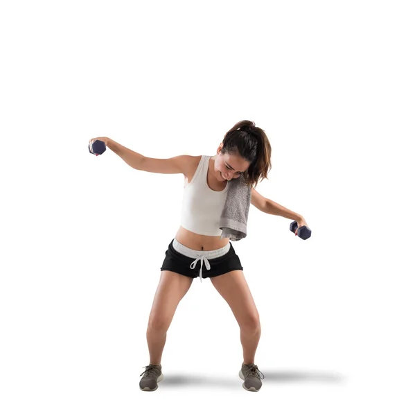 Awkward girl trying to lift weights — Stock Photo, Image