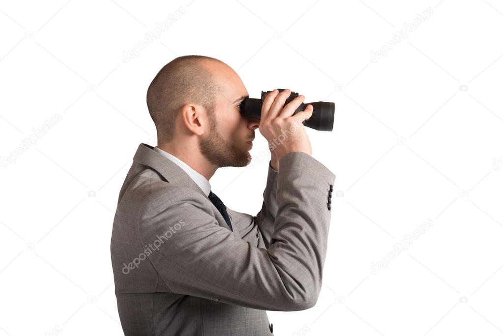 man looking carefully through binoculars