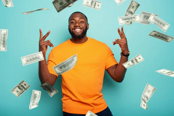 Boy wins money. Amazed and surprised expression face. Light blue background.