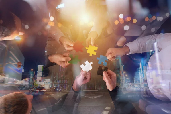 Teamwork of partners. Concept of integration and startup with puzzle pieces — Stock Photo, Image