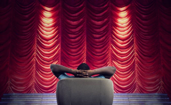 Mężczyzna relaksuje się na fotelu i ogląda spektakl w teatrze — Zdjęcie stockowe