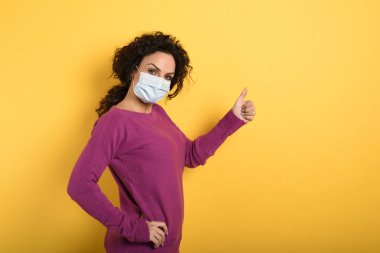 Kız covid 19 koronavirüsün yenilmesi konusunda iyimser. sarı arkaplan.