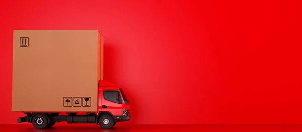 Big cardboard box package on a red truck ready to be delivered — Stock Photo, Image