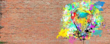 Big stylized light bulb on a big wall of bricks drawn with splashes of colored paint. Concept of innovation and creativity brick clipart