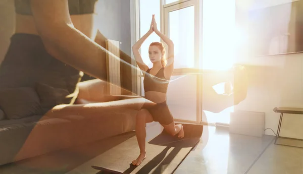 Young girl relaxing in yoga position in front of a bright window — Stock Photo, Image