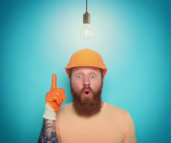 Incompetent worker is wondered about his work. cyan background — Stock Photo, Image
