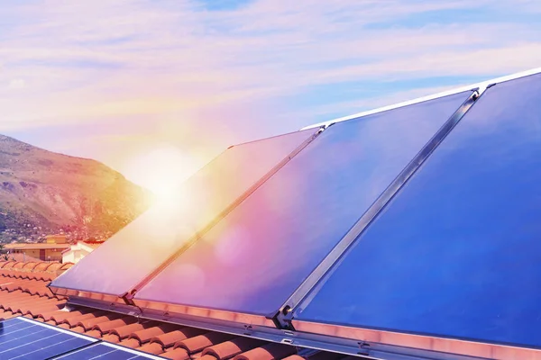 Renewable energy system with solar panel for electricity and hot water — Stock Photo, Image