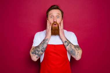 wondered isolated chef with beard and red apron
