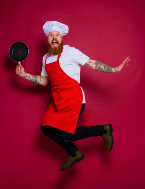 scared chef with beard and red apron jumps
