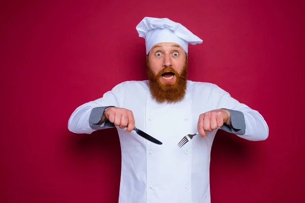 Shocked chef with beard and red apron is ready to cook — 스톡 사진