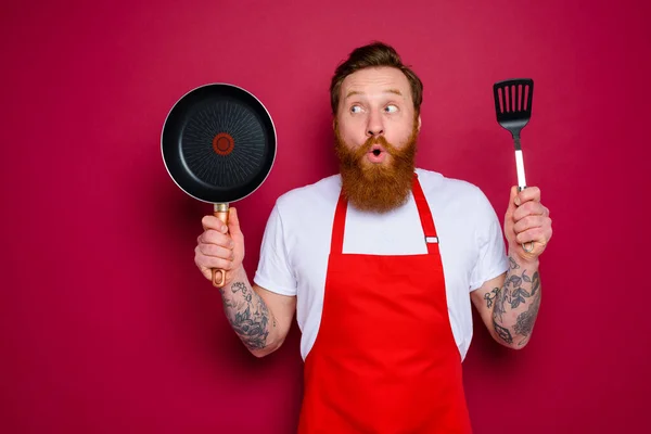 Chef sorpreso con barba e grembiule rosso è pronto da cucinare — Foto Stock