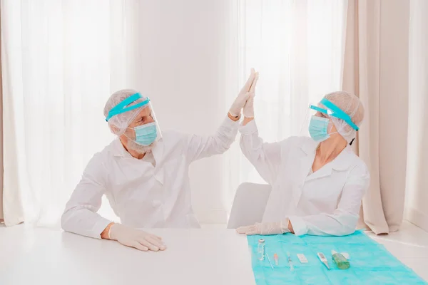 Médicos con máscara y protector facial están listos para trabajar en el hospital —  Fotos de Stock