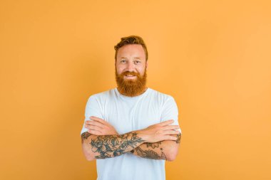 Happy man with beard, tattoo and white t-shirt