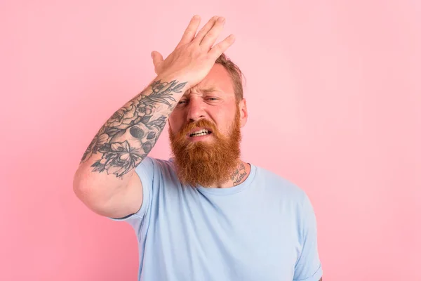 Delusion man with beard and light blue t-shirt — Stock Photo, Image