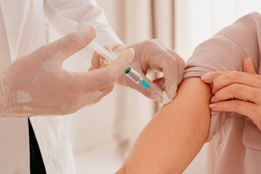 Maskeli ve şırıngalı doktor Covid 19 'a karşı aşı uygulamaya hazır.