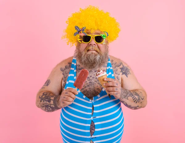 Fat man with beard and wig eats a popsicle and an icecream — Stock Photo, Image