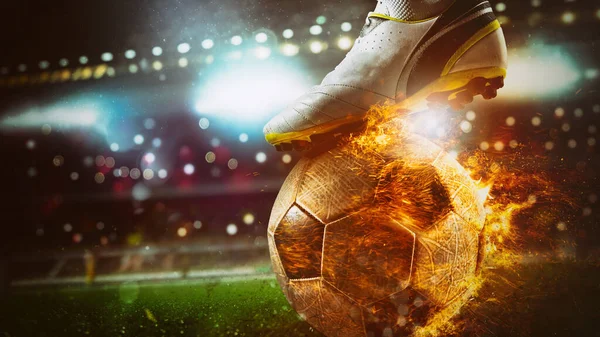 Close up of a soccer striker ready to kicks a fiery ball at the stadium — Stock Photo, Image