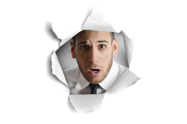 Man looking through paper hole — Stock Photo, Image