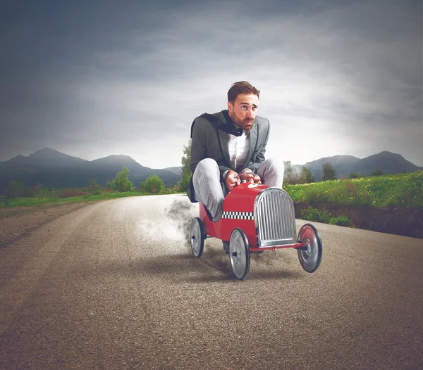 Businessman driving fast car — Stock Photo, Image