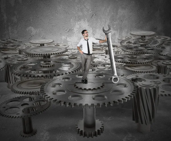 Businessman makes maintenance of gears — Stock Photo, Image