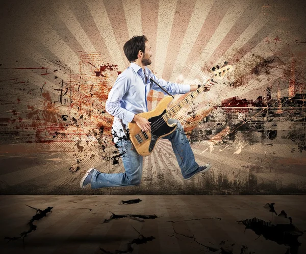 Man jumping with bass guitar