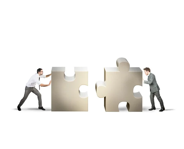 Two businessman pushing puzzle pieces — Stock Photo, Image