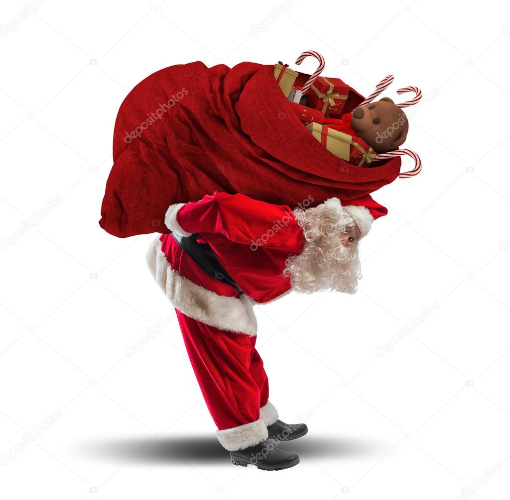 Santaclaus carrying heavy gift sack