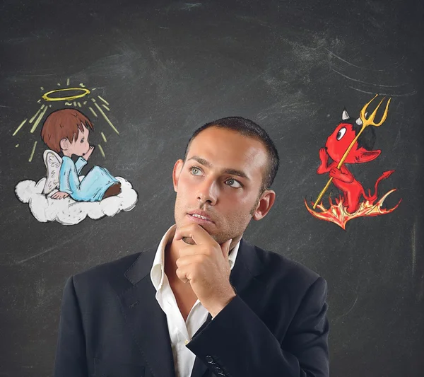 Businessman between good and evil — Stock Photo, Image