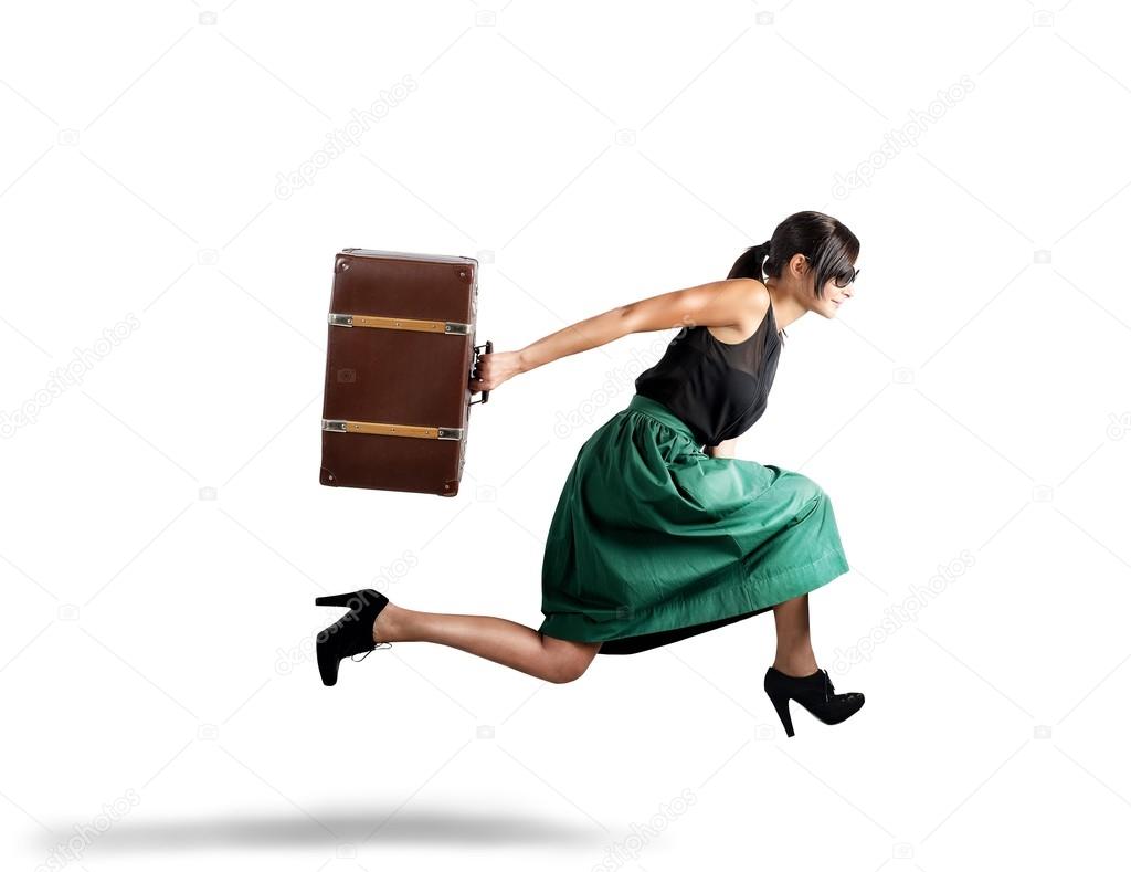 Woman runs with suitcase