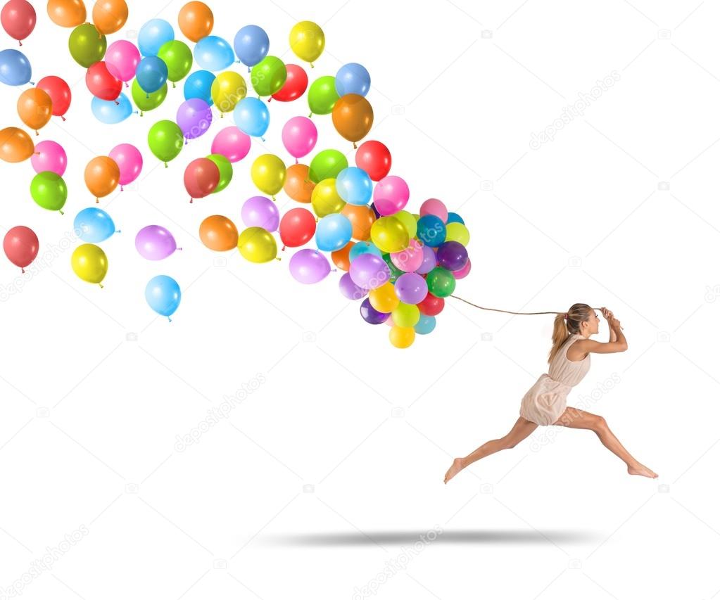 Girl jumping with balloons