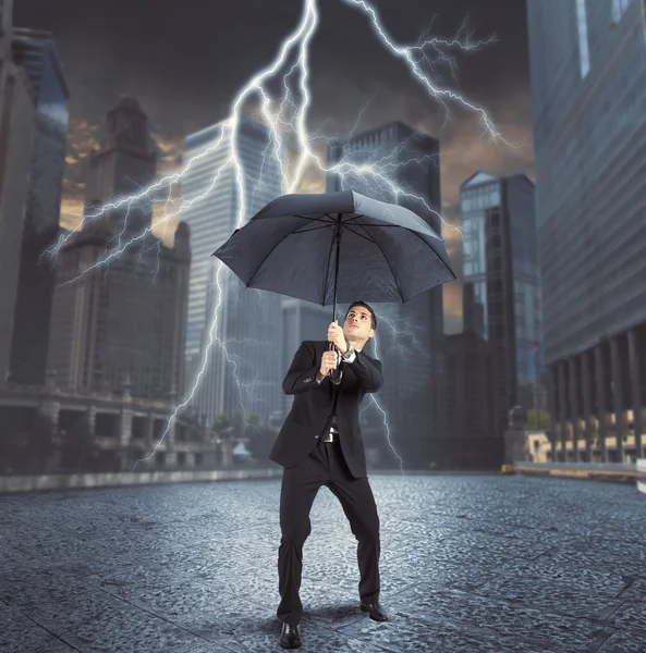 Businessman against thunder and lightning — Stock Photo, Image