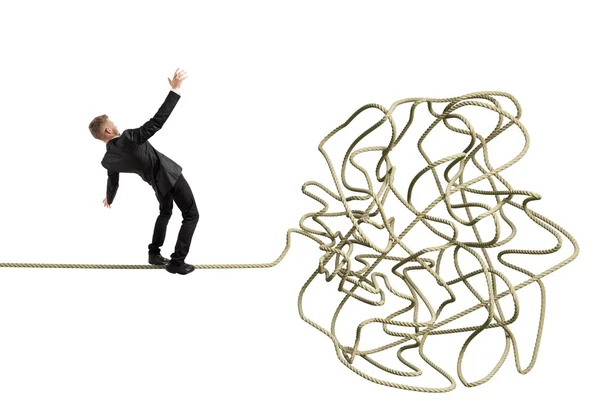 Businessman balancing on rope — Stock Photo, Image