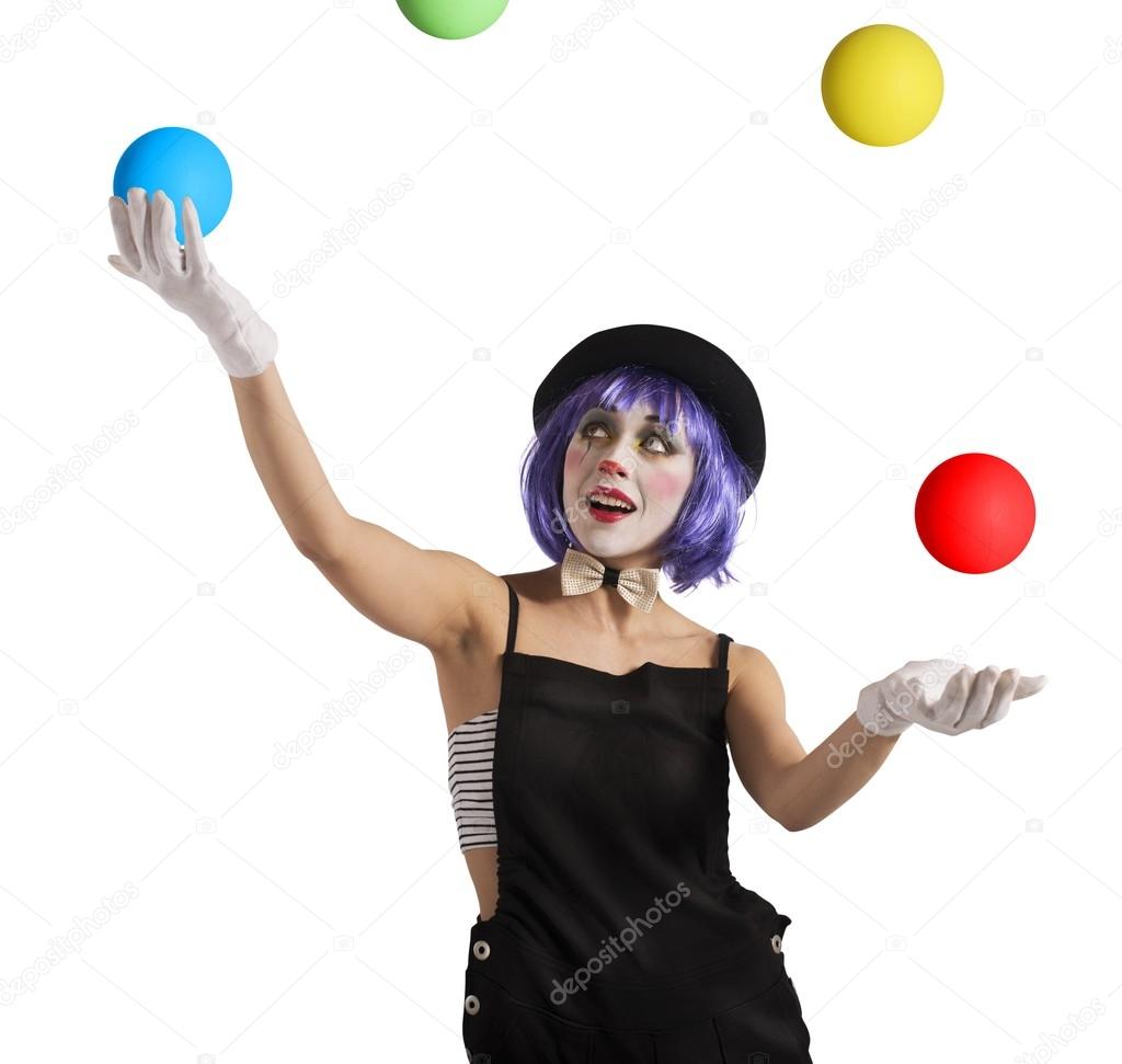 Clown playing with colorful balls