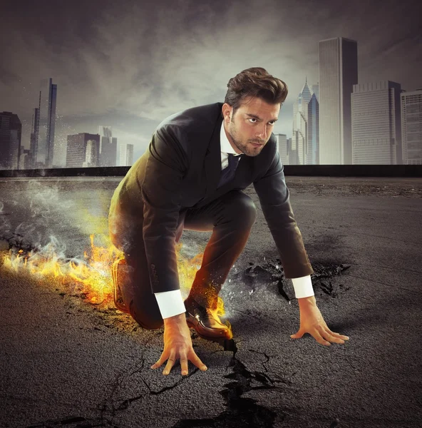 Businessman leaving fire trails on asphalt — Stock Photo, Image