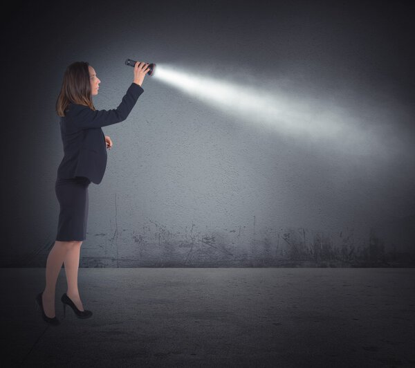Businesswoman with a torch lights