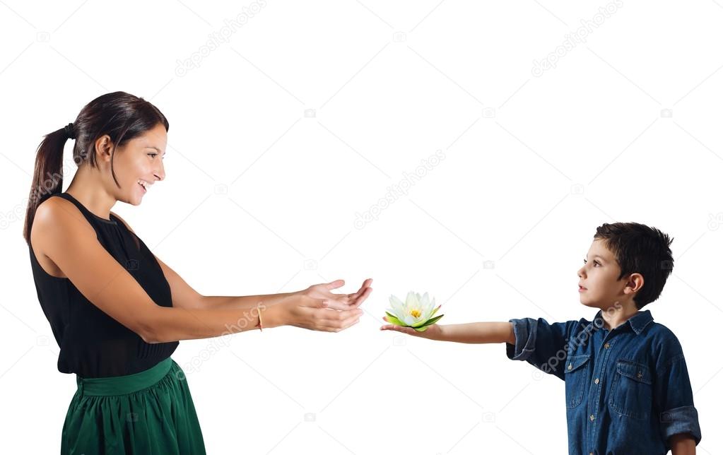 Child gives a flower to woman